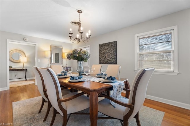 dining area featuring a chandelier and light hardwood / wood-style floors