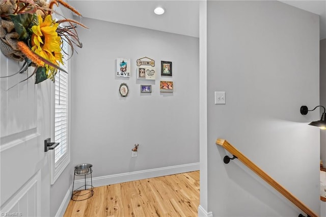 laundry area featuring a wealth of natural light and wood-type flooring