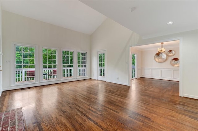 1807 Millhouse Ct, Greensboro, NC 27407 - unfurnished living room featuring high vaulted ceiling, wood finished floors, and a chandelier