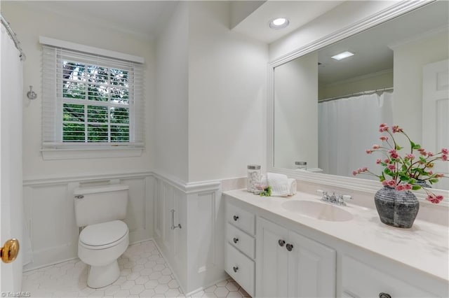 1807 Millhouse Ct, Greensboro, NC 27407 - full bathroom featuring ornamental molding, vanity, a wainscoted wall, tile patterned flooring, and a decorative wall