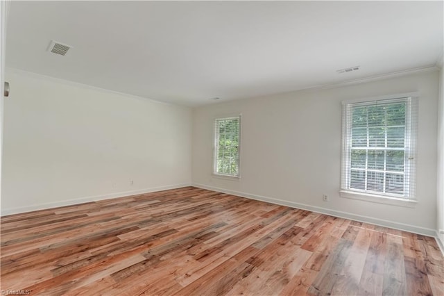 1807 Millhouse Ct, Greensboro, NC 27407 - empty room with healthy amount of natural light, ornamental molding, and light wood-type flooring