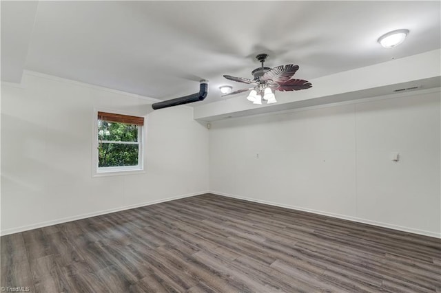 1807 Millhouse Ct, Greensboro, NC 27407 - spare room with dark wood-type flooring, a ceiling fan, and ornamental molding