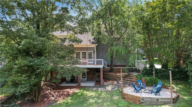 1807 Millhouse Ct, Greensboro, NC 27407 - back of house featuring a patio, an outdoor fire pit, a wooden deck, and a lawn