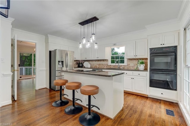 1807 Millhouse Ct, Greensboro, NC 27407 - kitchen featuring black appliances, dark wood-style floors, tasteful backsplash, white cabinetry, and crown molding