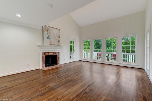 1807 Millhouse Ct, Greensboro, NC 27407 - unfurnished living room featuring high vaulted ceiling, wood finished floors, and a fireplace
