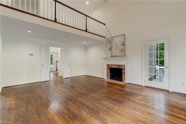 1807 Millhouse Ct, Greensboro, NC 27407 - unfurnished living room with a high ceiling, a fireplace, wood finished floors, crown molding, and recessed lighting