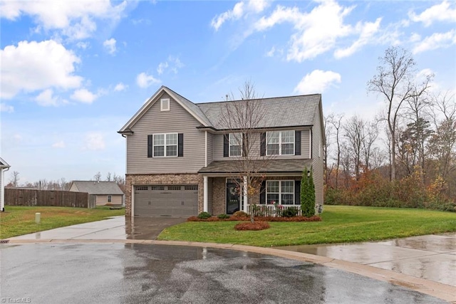 view of front of property featuring a front lawn and a garage