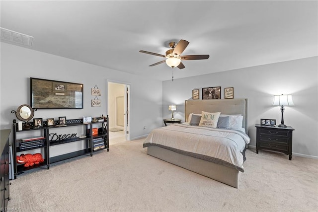 carpeted bedroom featuring connected bathroom and ceiling fan