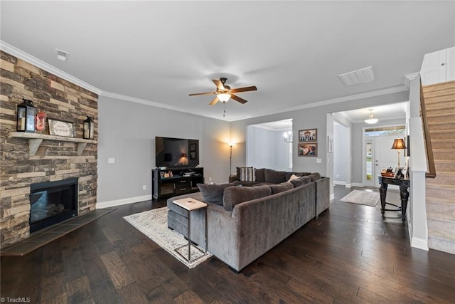 living room featuring a fireplace, dark hardwood / wood-style floors, ceiling fan, and ornamental molding