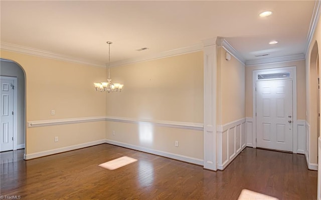 interior space featuring visible vents, arched walkways, wood finished floors, crown molding, and a chandelier