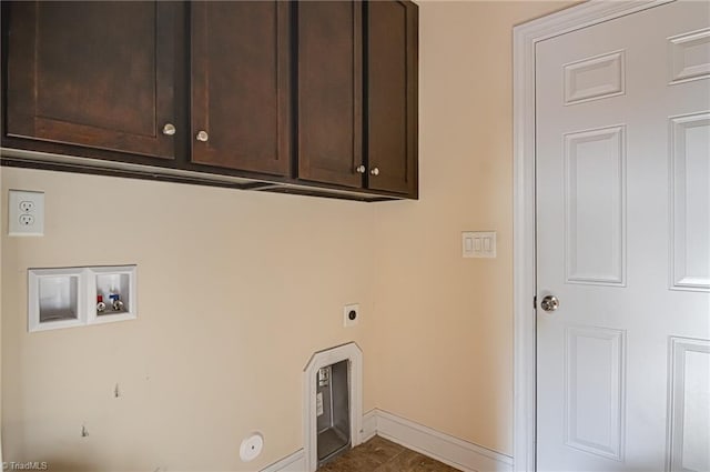 clothes washing area with hookup for a washing machine, cabinet space, hookup for an electric dryer, and baseboards