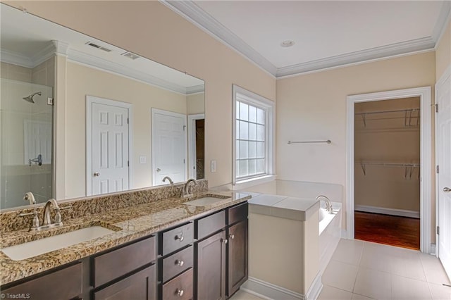 bathroom with a stall shower, a sink, and crown molding