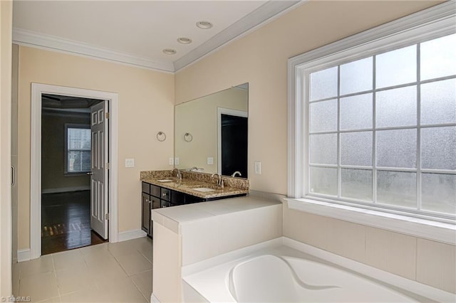 full bathroom featuring double vanity, a sink, a bath, and crown molding