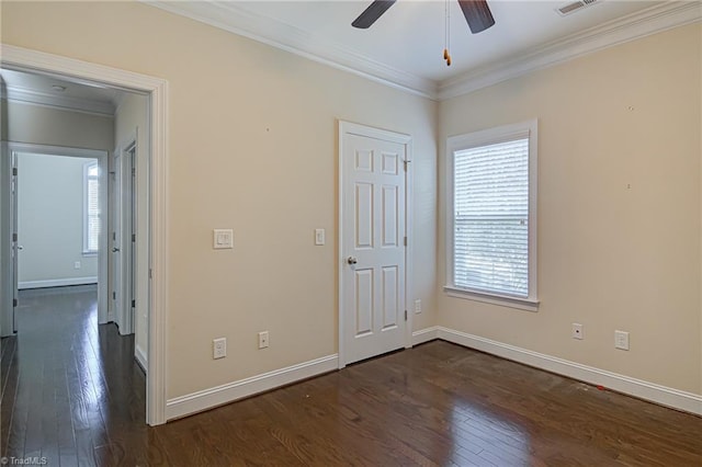 unfurnished bedroom with dark wood-style floors, multiple windows, and crown molding