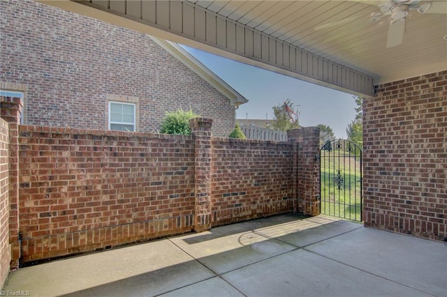 view of patio / terrace featuring ceiling fan, a gate, and fence