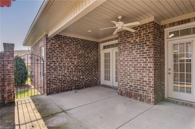 view of patio / terrace with a ceiling fan and a gate