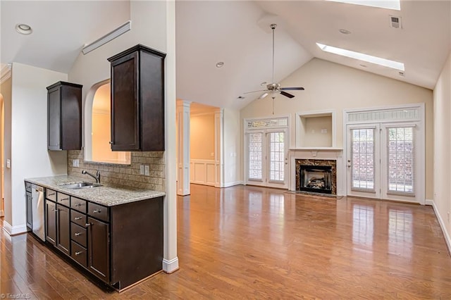 kitchen featuring dark brown cabinetry, plenty of natural light, and a sink