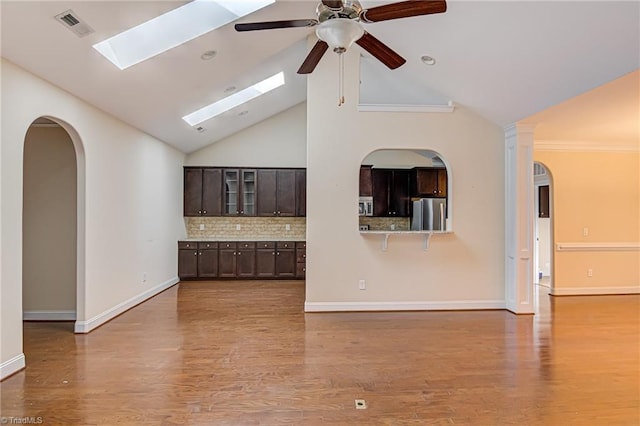 unfurnished living room with visible vents, baseboards, and wood finished floors