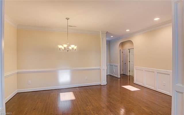 unfurnished room with arched walkways, a decorative wall, ornamental molding, wood-type flooring, and an inviting chandelier