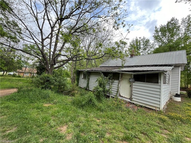 back of property featuring metal roof