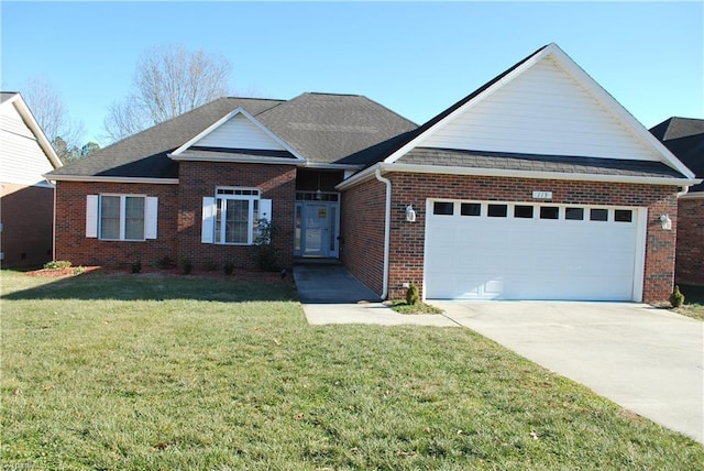 view of front of property with a garage and a front lawn