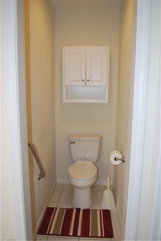 bathroom with toilet and tile patterned flooring