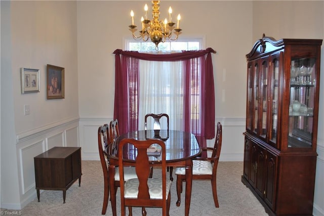 dining room featuring light carpet and an inviting chandelier