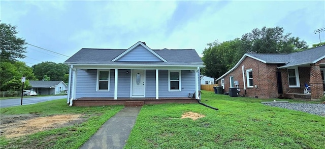 bungalow-style home featuring covered porch and a front yard