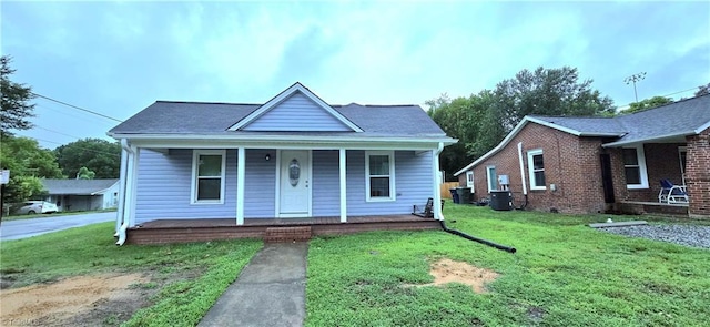 bungalow-style house with covered porch and a front yard