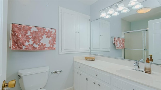 bathroom featuring toilet, walk in shower, and vanity