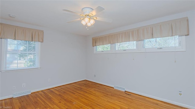 empty room featuring ceiling fan and light hardwood / wood-style floors