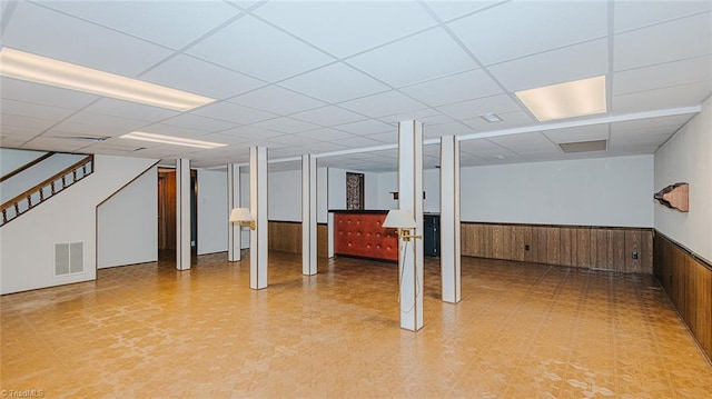 basement featuring wood walls