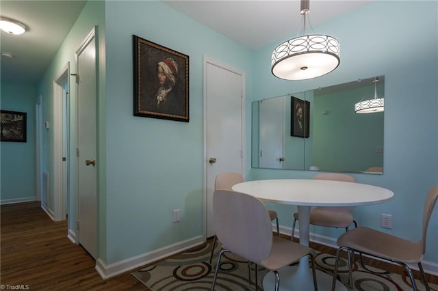 dining space with hardwood / wood-style floors