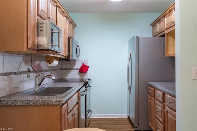 kitchen with sink, decorative backsplash, dark hardwood / wood-style floors, and appliances with stainless steel finishes