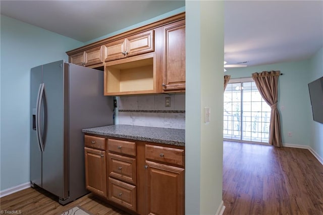 kitchen with decorative backsplash, dark hardwood / wood-style floors, and stainless steel refrigerator with ice dispenser