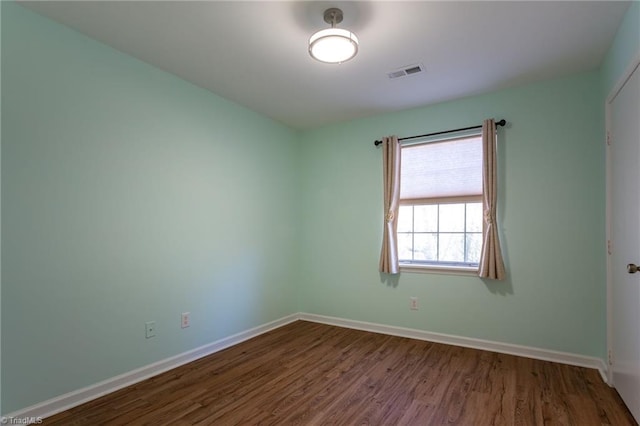 empty room featuring wood-type flooring