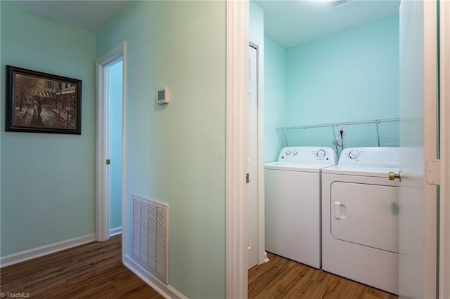 laundry area featuring hardwood / wood-style flooring and independent washer and dryer