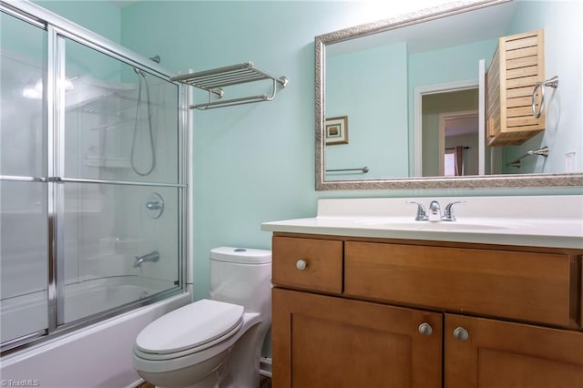 full bathroom with shower / bath combination with glass door, vanity, and toilet