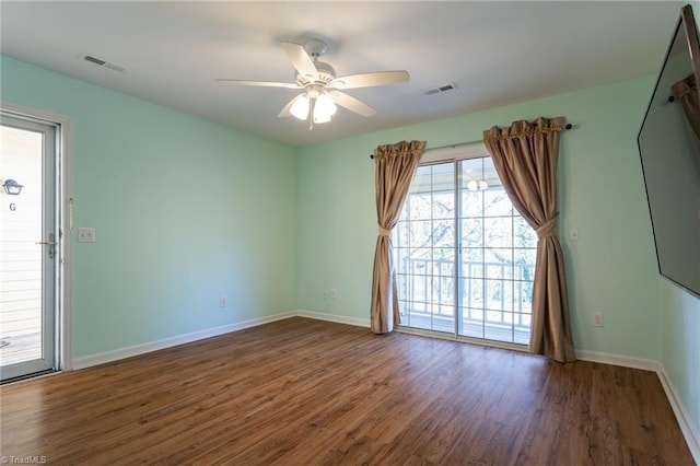 unfurnished room with dark hardwood / wood-style flooring and ceiling fan