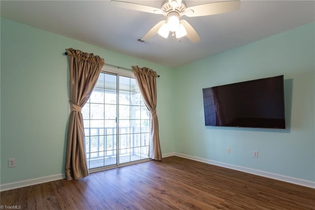 empty room with dark wood-type flooring and ceiling fan