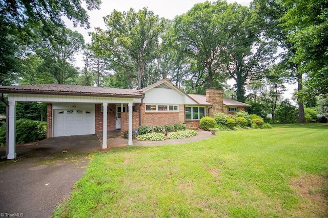 7040 Franklin Rd, Lewisville, NC 27023 - ranch-style home with asphalt driveway, a garage, a front yard, a chimney, and brick siding