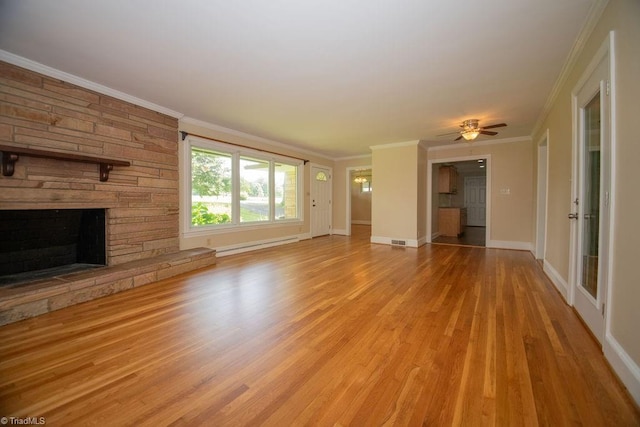 7040 Franklin Rd, Lewisville, NC 27023 - unfurnished living room with a baseboard radiator, light wood-type flooring, a stone fireplace, ceiling fan, and ornamental molding