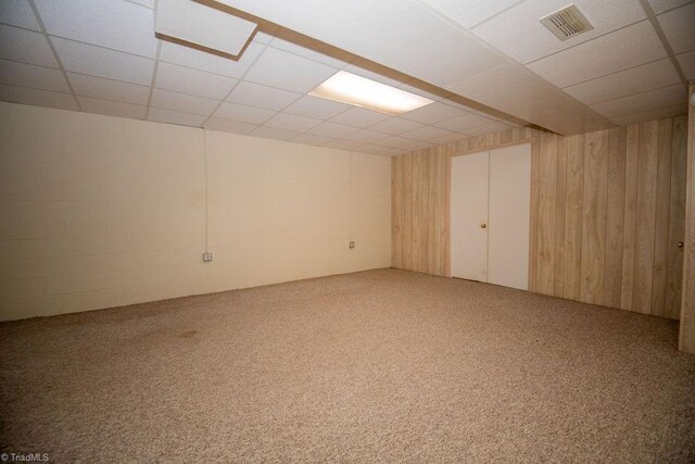 7040 Franklin Rd, Lewisville, NC 27023 - finished below grade area featuring carpet flooring, a drop ceiling, and wooden walls
