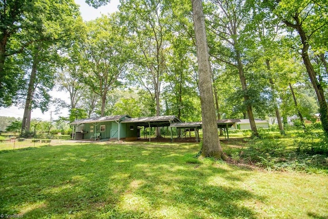 7040 Franklin Rd, Lewisville, NC 27023 - view of grassy yard featuring a carport