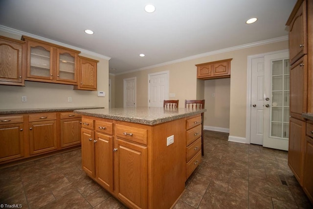 7040 Franklin Rd, Lewisville, NC 27023 - kitchen with brown cabinetry, glass insert cabinets, a center island, recessed lighting, and ornamental molding