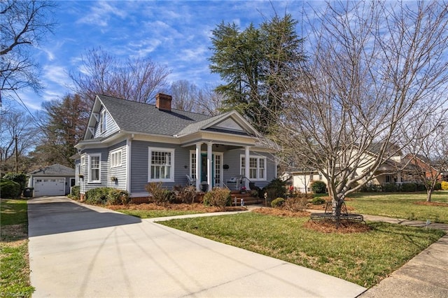 view of front of home featuring an outdoor structure, driveway, roof with shingles, a front lawn, and a chimney