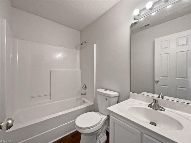 full bathroom featuring toilet, bathing tub / shower combination, a textured ceiling, vanity, and hardwood / wood-style flooring