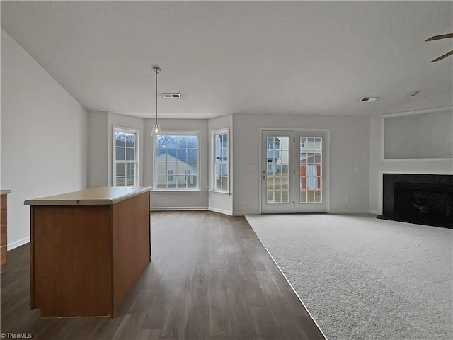 unfurnished living room with dark wood-type flooring and ceiling fan