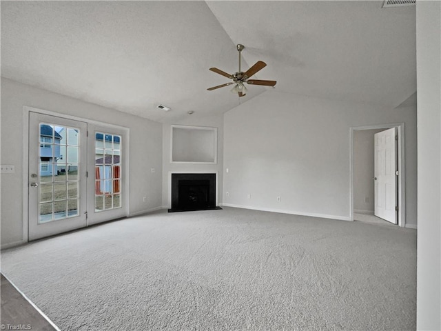 unfurnished living room with ceiling fan, vaulted ceiling, and carpet