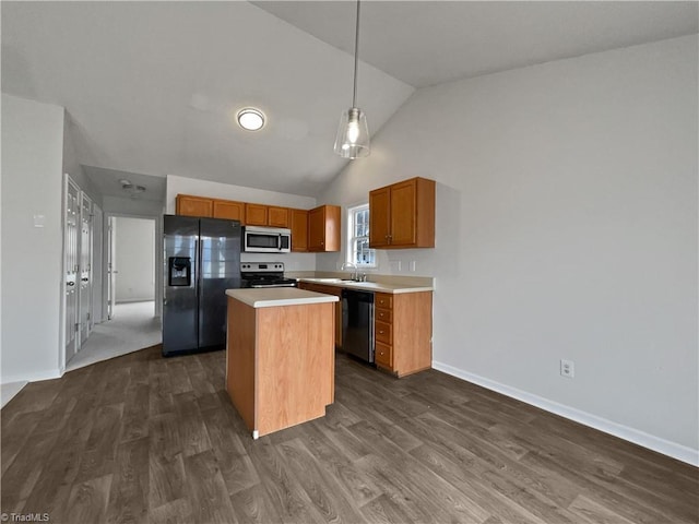 kitchen featuring dark hardwood / wood-style flooring, hanging light fixtures, a kitchen island, and appliances with stainless steel finishes